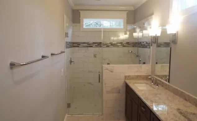 Bathroom with marble subway shower and granite vanity