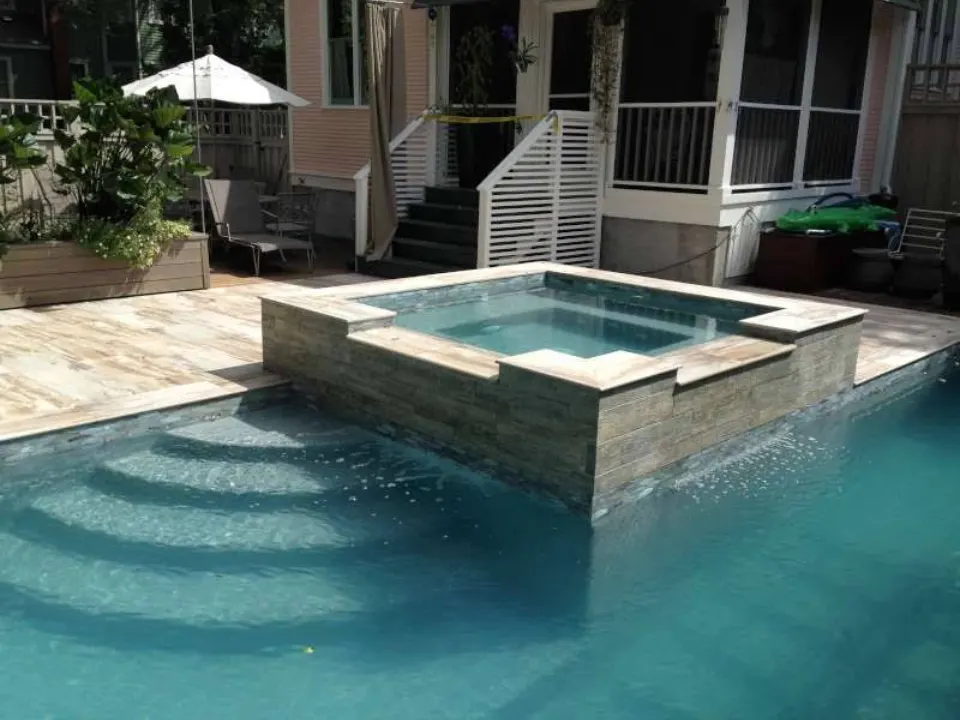 Custom stone tile spa and pool surround