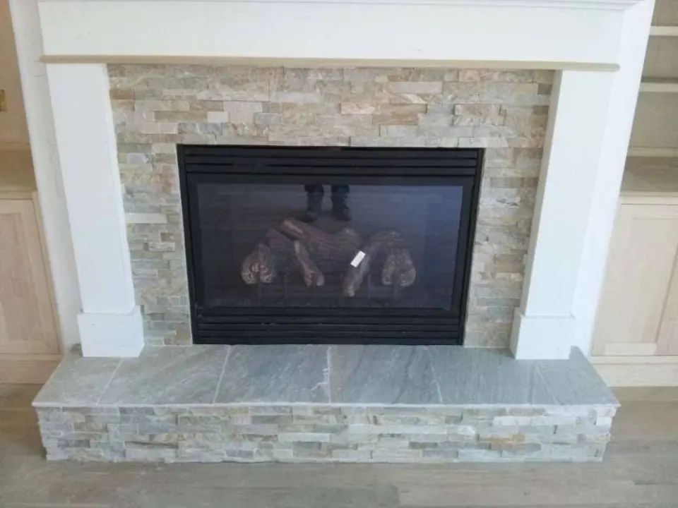 Stacked stone fireplace surround and hearth