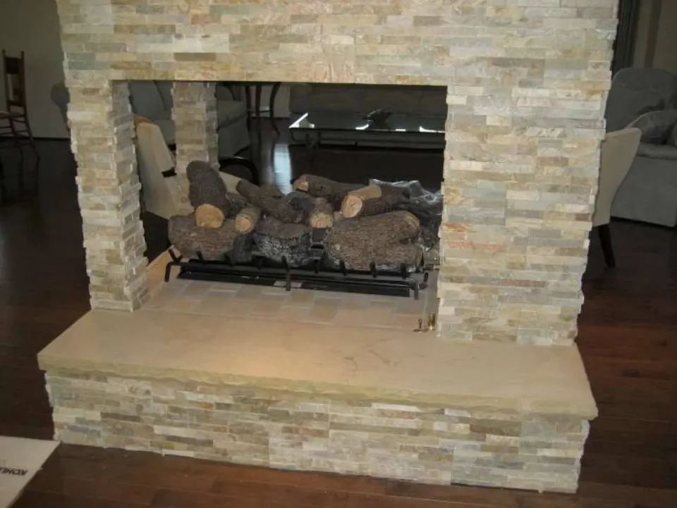 Two-sided stacked stone fireplace